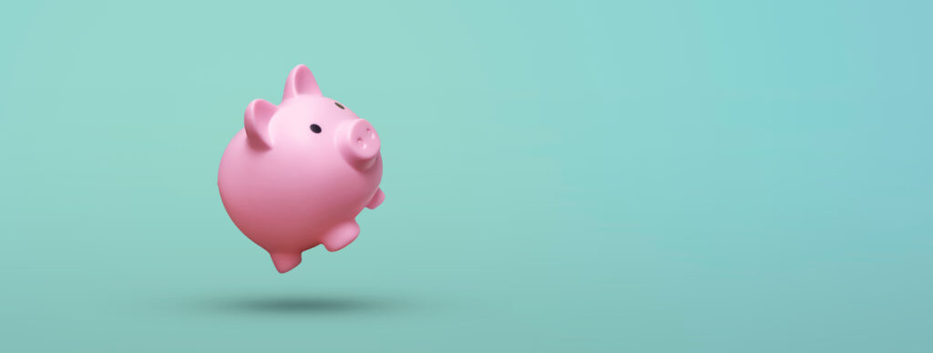Pink piggy bank floating on blue background - Tradeinfo.cz FIRE
