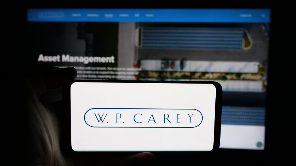 Stuttgart Germany - 03-07-2025 Person holding cellphone with logo of US real estate company W P Carey Inc on screen in front of business webpage Focus on phone display - Tradeinfo.cz